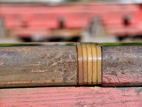 Rail joint pad electrically isolates rails and is secured in place with red.. Stock Photos