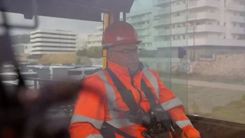 Rail Operator in Orange PPE Inside Locomotive Cab Stock Footage 338371640