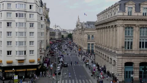 Rail passengers hurry to Paris' Gare-du-Nord as French flag flies overhead Stock Footage 245398564