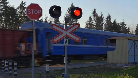 Rail road crossing with freight train passing by Видео 75787053