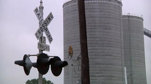 Rail Road crossing with grain elevators in background Stock-Footage 43895498