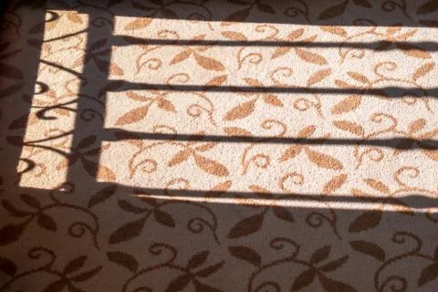 Rail shadow on a carpet. Stock Photos