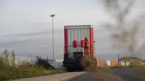 Rail Worker on Rear of Freight Train Wagon in Industrial Area, Le Havre, France Stock Footage 337976243