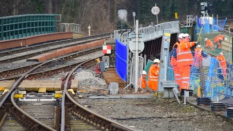 Rail workers working on railway tracks on rail bridge across  river ouse york uk Stock Footage 116605693