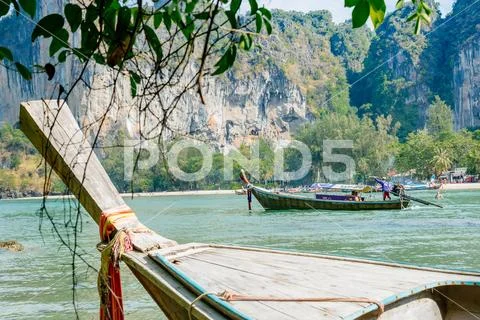 Railay, Krabi Province, Thailand - February 17, 2019: A man drives a long tai Stock Photos