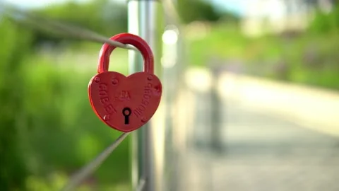 On the railing hangs a wedding lock of red in the form of a heart. Stock Footage 199597386