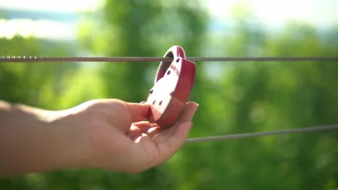 On the railing hangs a wedding lock of red in the form of a heart. Stock Footage 199597517