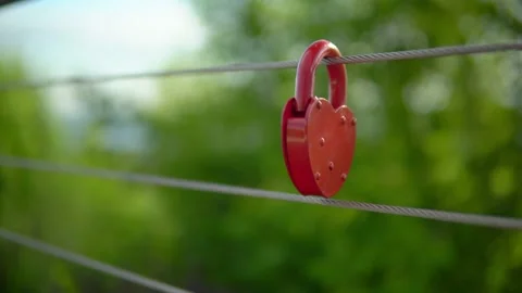 On the railing hangs a wedding lock of red in the form of a heart. Stock Footage 199597563