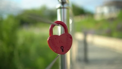 On the railing hangs a wedding lock of red in the form of a heart. Stock Footage 199597605