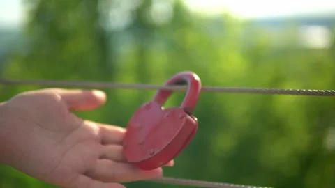 On the railing hangs a wedding lock of red in the form of a heart. Stock Footage 199597701