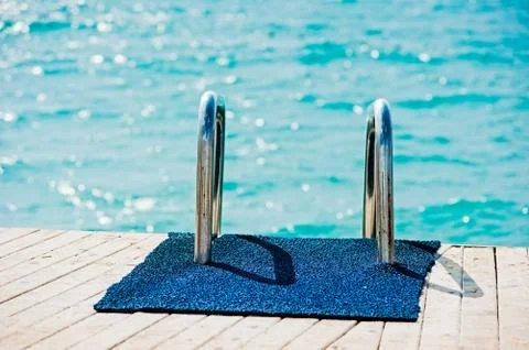 Railing ladder going down to the pier into the sea. Stock Photos