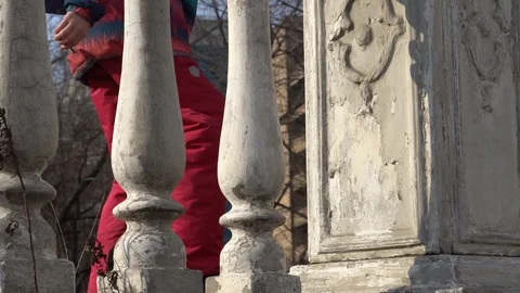 A railing of small columns and a child with a backpack passes by Stock Footage 124760403
