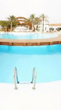 Railing stairs down to the pool with fresh water Stock Photos