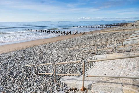 Railings and steps lead down to Barmouth beach Stock Photos