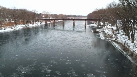 Railroad Bridge in the Middle of Icy River AERIAL FLY IN Stock Footage 102587437