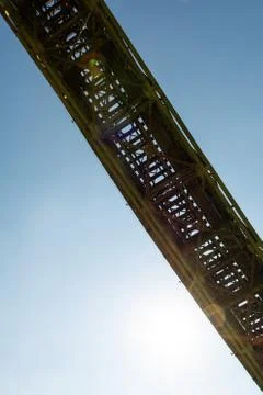 Railroad bridge structure viewed from below with clear sky in background Stock Photos
