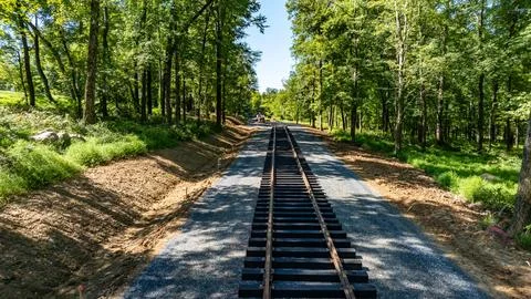 Railroad Construction Progresses Through a Green Landscape on a Sunny Day 스톡 사진