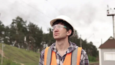 A railroad engineer examines damage to power lines. Stock Footage 241580640