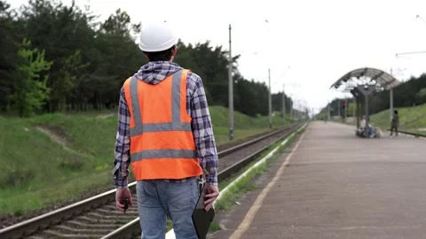 A railroad engineer makes an inspection of the railroad track for reconstruction Stock Footage 243003198