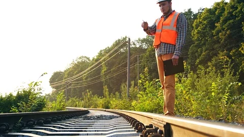 Railroad engineer works on a track that needs to be replaced Stock Footage 96014706