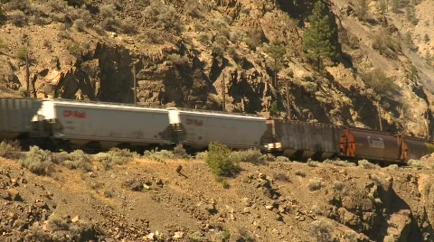 Railroad, freight train arid hillside Stock Footage