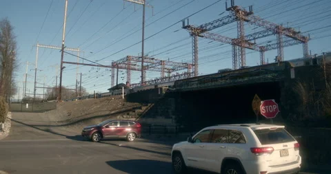 Railroad Intersection, Cars and Train Passing over Bridge Stock Footage 233141468