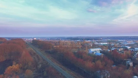 Railroad near brickwork plants and factories at sunset Stock Footage