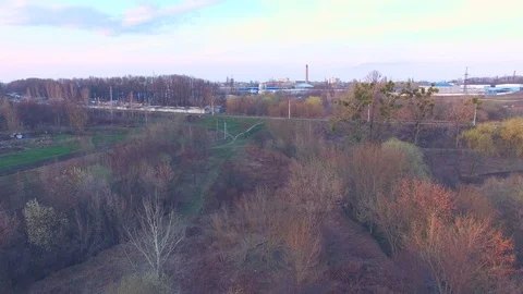 Railroad near brickwork plants and factories at sunset Stock Footage