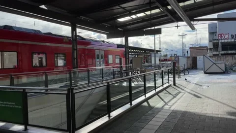 Railroad station. The red train stay on the platform. German railways. Sunny. Stock Footage 221321253