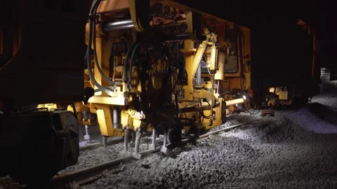Railroad tamping machine in operation during track maintenance Stock Footage 328989918