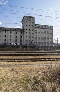Railroad tracks and a train against the backdrop of an abandoned and destroye Stock Photos