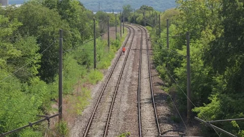 Railroad worker inspecting tracks in rural area Stock Footage 345928442