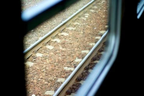 Rails shot through the window from inside of a fast, driving train. Stock Photos