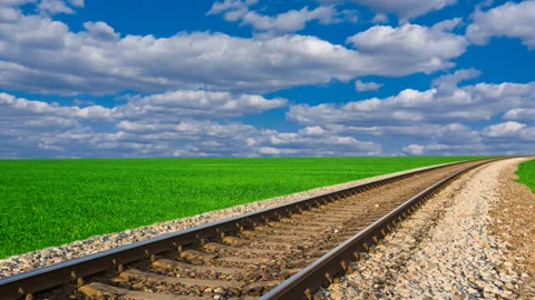 Railway among a green fields under a cloudy sky Stock Footage 152388292