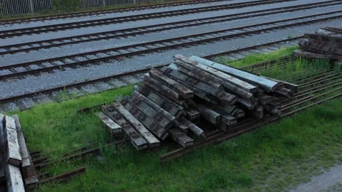 Railway beam sleeper Railroad tie on a bounch next to the tracks Stock Footage