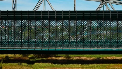 Railway bridge featuring solid steel enclosure with dense diagonal lattice and Stock Footage 315035209