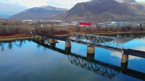 Railway bridge over the river at dawn with mountains in the background. 스톡 동영상 145164675
