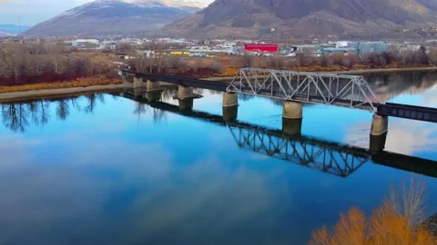 Railway bridge over the river at dawn with mountains in the background. 動画素材 145164992