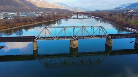 Railway bridge over the river at dawn with mountains in the background. 動画素材 145165362