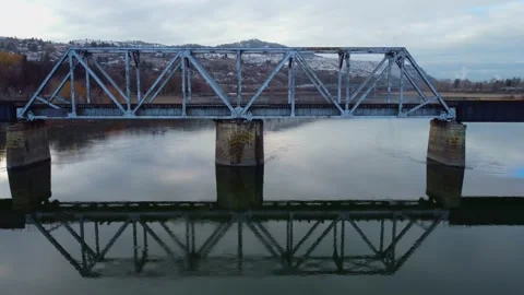 Railway bridge over the river at dawn with mountains in the background. 動画素材 145165712