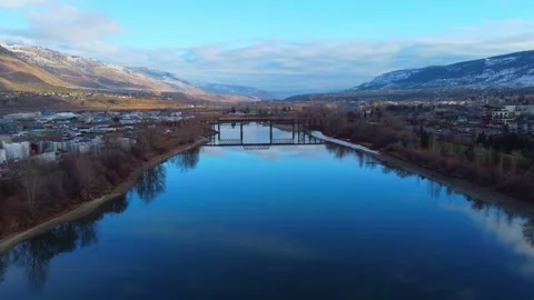 Railway bridge over the river at dawn with mountains in the background. 動画素材 145165772