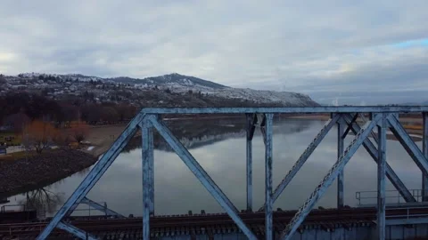Railway bridge over the river at dawn with mountains in the background. Vídeo Stock 145165923