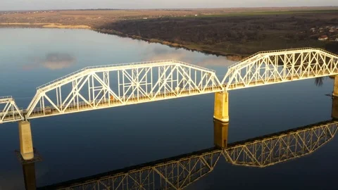Railway bridge over the river with reflection on the water Stock Footage 123294656