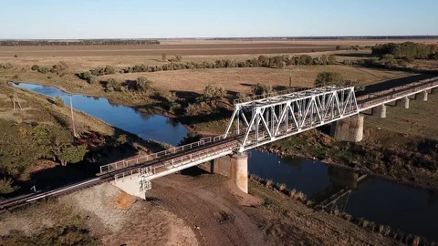 Railway bridge over a small river, fields in the background Stock Footage 97066334