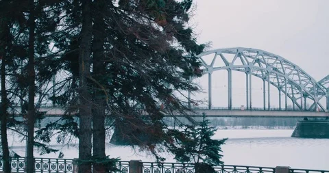 Railway Bridge in the Snow behind the trees - Riga, Latvia (4K) Stock Footage 102262629