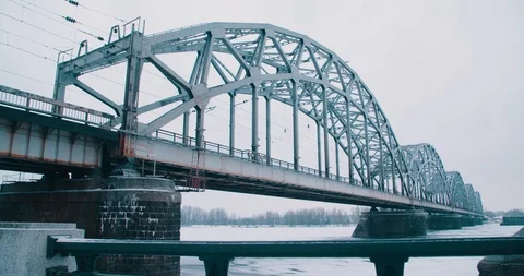Railway Bridge in the Snow from Riverside - Riga, Latvia (4K) Stock Footage 102238292