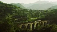 Railway Bridge With Train In Mountains. 4K Stock Footage