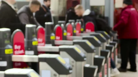 Railway Commuters Pulling Suitcases and Luggage Through Ticket Barriers Stock Footage 166025108