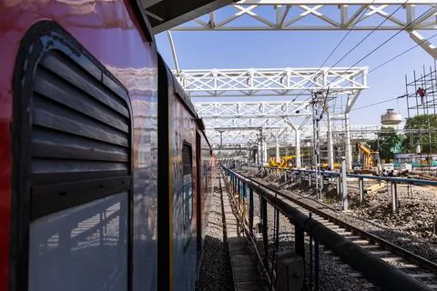 Railway construction work with overhead structures scaffolding workers at d.. Stock Photos