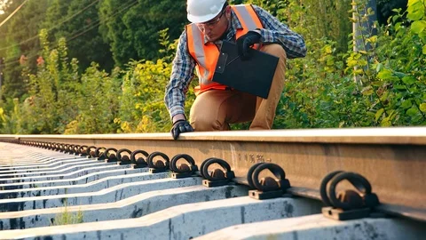 Railway engineer checks the track stance and records the data Stock Footage 96019032